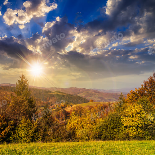 Preview: Yellow And Orange Trees On Autumn Meadow In Mountains At Sunset