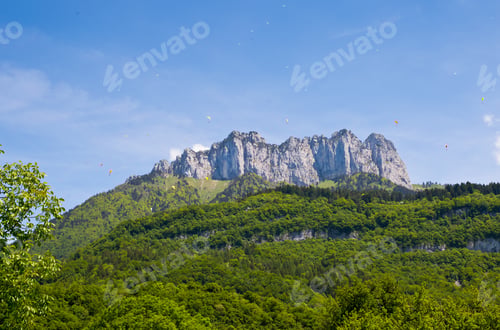 Preview: Paragliding Flying Over Blue Sky In French Alps.