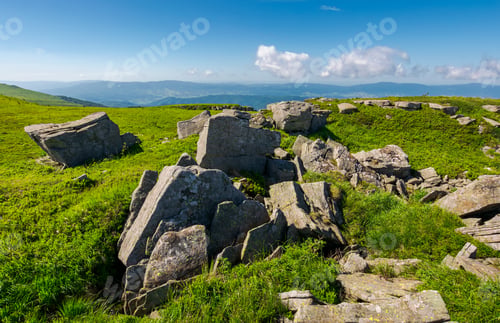 Preview: Range Of Stones On The Grassy Hill. Beautiful Summer Landscape With Fluffy Clouds Above The Distant