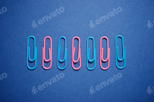 Preview: Paperclips Group On A Blue Table.