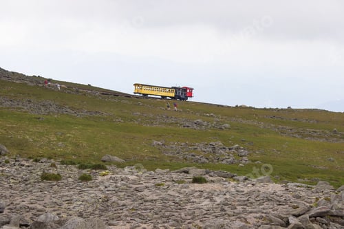 Preview: Mountain Landscape With Cog Railway Steam Train Slowly Driving Up The Mountain