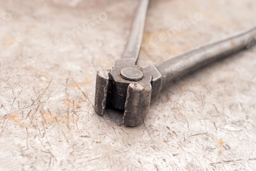 Preview: Old Pincers Lie On A Rusty Shabby Metal Surface