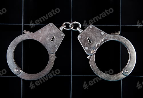 Preview: Handcuffs On The Black Background Closeup