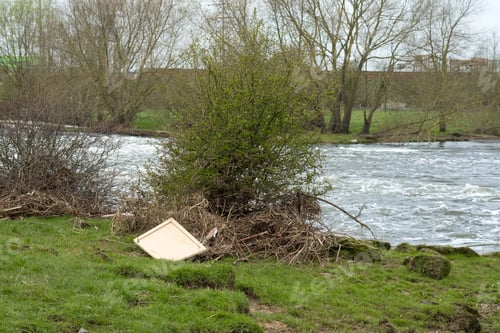Preview: Washed Up Flood Debris Next To A River