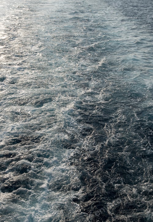 Preview: The Wake Of A Cruise Ship Sailing On The Ocean, With Blue Water And Waves
