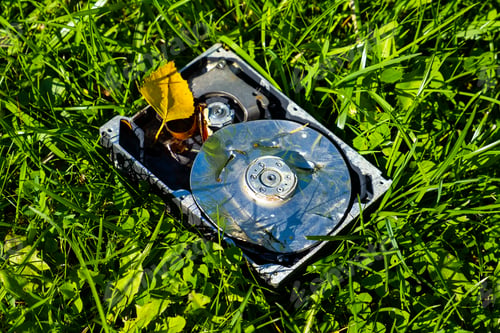 Preview: Crushed Hard Disk Drive On The Grass Closeup
