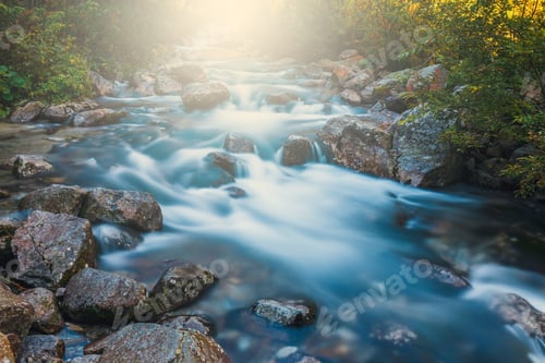 Preview: Beautiful Waterfall In The Mountains With The Rays Of The Sun Shining Through The Trees