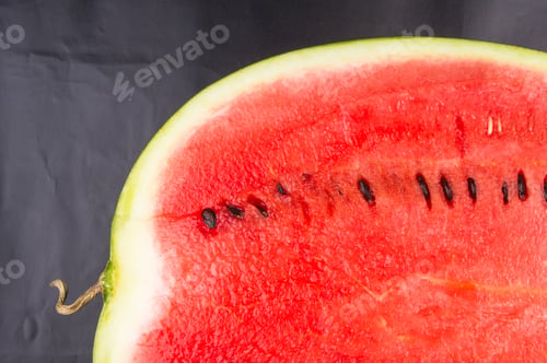 Preview: Half Of Ripe Watermelon On A Black Background