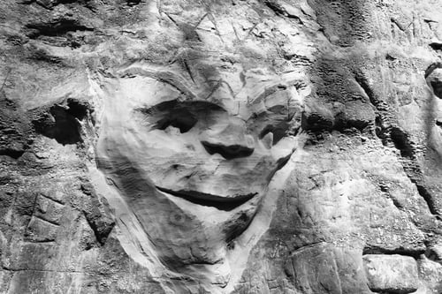 Preview: Shutes Lane, Symondsbury, Dorset, England - May 6 2019: The Rustic Carving Of A Face Into The