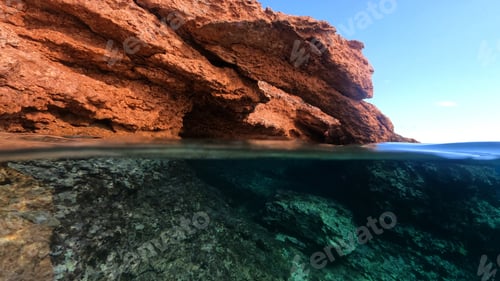 Preview: Underwater Above And Below Photo Of Rocky Seascape Arch Forming A Beautiful Emerald Lagoon In