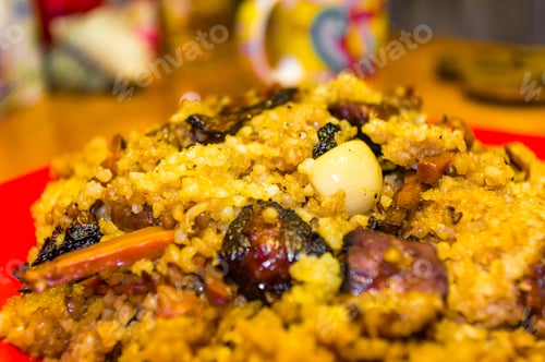 Preview: Uzbek Pilaf With Meat In A Red Plate On A Wooden Table, Close Up