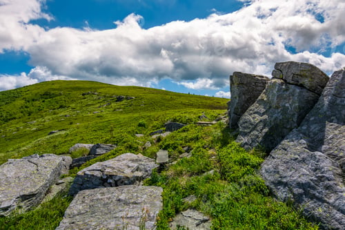 Preview: Giant Rocks On A Hill In Summertime. Beautiful Landscape Under The Blue Sky With Some Clouds