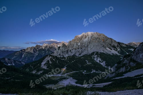 Preview: View Of The Mountain Pas Vrsic With Two Cottages. It Is Early Evening And Stars Are Just Starting
