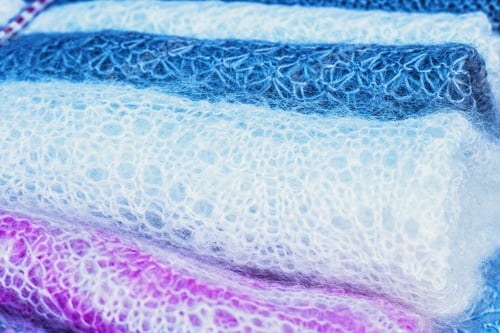 Preview: Knitted Pink, White And Gray Woolen Fabric Close Up. Winter Wear Knitted Fabric Texture.