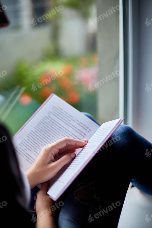 Preview: Beautiful Young Woman Reading Book Near Window At Home