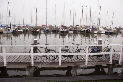 Preview: Bikes Parked On The Jetty, Yachts And Boats Anchored At Harbor Pier