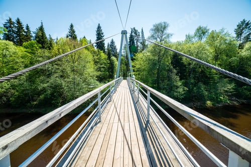 Preview: Foot Bridge Over Forest River In Summer In Green Foliage