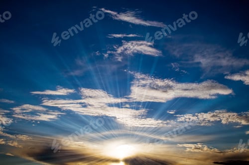 Preview: Background Cloudscape With Sunbeam Blue Sky Over It