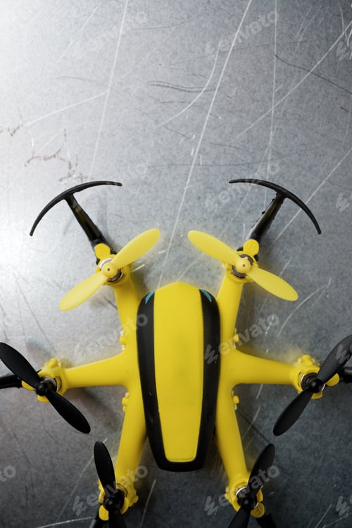 Preview: Yellow Drone On A Metal Table.