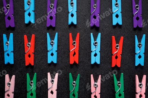 Preview: Small Clothespins On A Black Table.