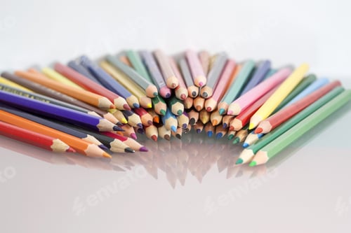 Preview: Group Of Sharp Colored Pencils With White Background And Reflexions