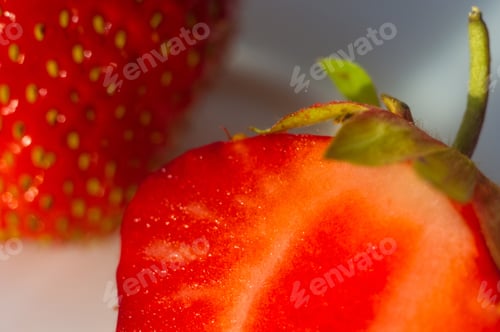 Preview: Half Of The Cut Fresh Ripe Berries Strawberries On White Plate, Macro Photo