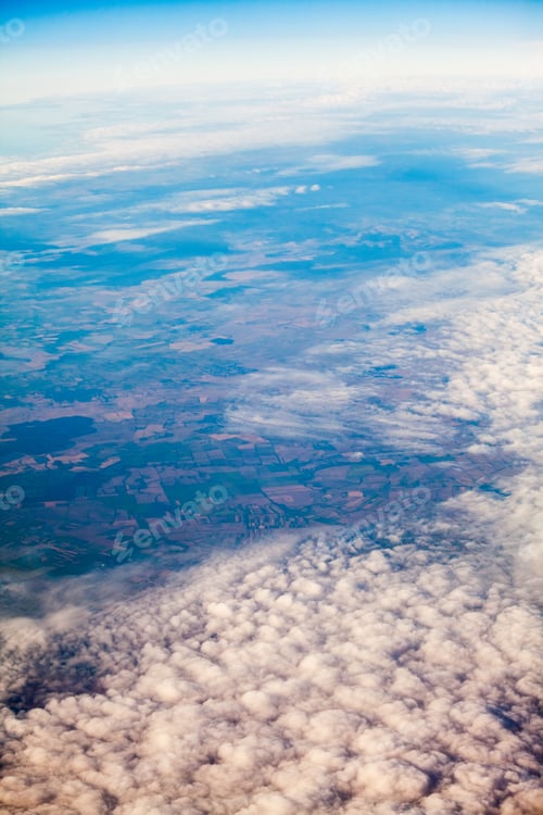 Preview: Farmland and Cloudscape Viewed from Airplane Window