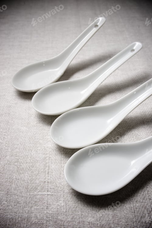 Preview: Small White Spoons On A White Tablecloth