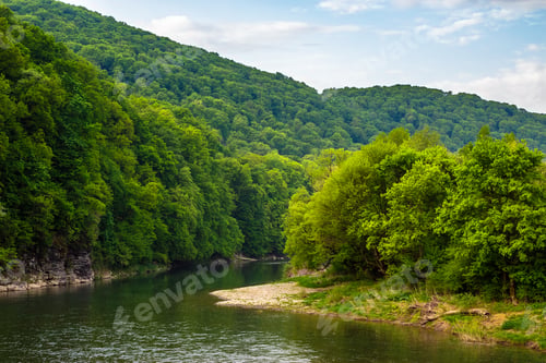 Preview: Mountain River With Stones On The Shore In The Forest Near The Mountain Slope