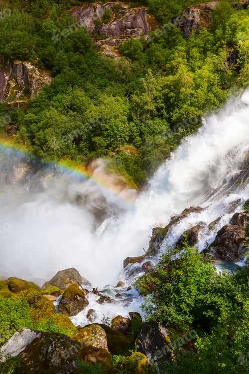 Preview: Waterfall And Rainbow On The Way To Briksdal Or Briksdalsbreen Glacier In Olden, Norway And Green