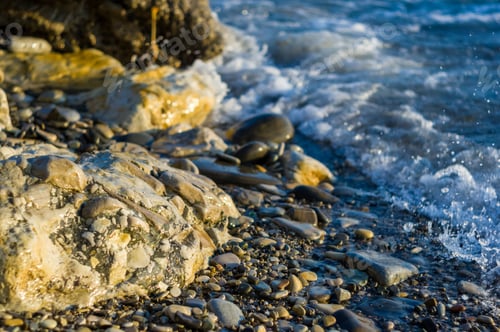 Preview: Pebble Stones On The Sea Beach On A Warm Summer Day, The Rolling Waves Of The Blue Sea With White