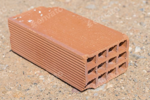 Terracotta Brick With Holes on Sandy Ground
