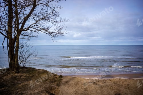 Preview: Storm Clouds Forming Over Clear Sea Beach With Rocks And Clear Sand. Dramatic Colors