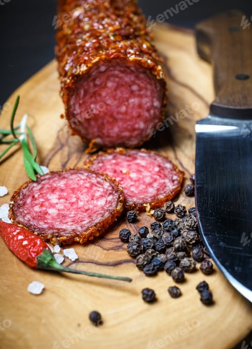 Preview: Dried Salami Crusted In Ground Red Pepper On Dark Background