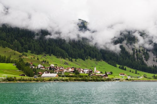 Preview: Swiss Village In A Low Clouds. Switzerland Alps