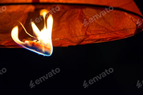 Preview: Burning Fire In Orange Sky Lantern Of Wish Flying In The Dark Sky
