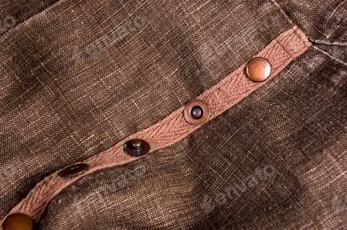 Preview: Close Up of Brown Fabric With Button Detail