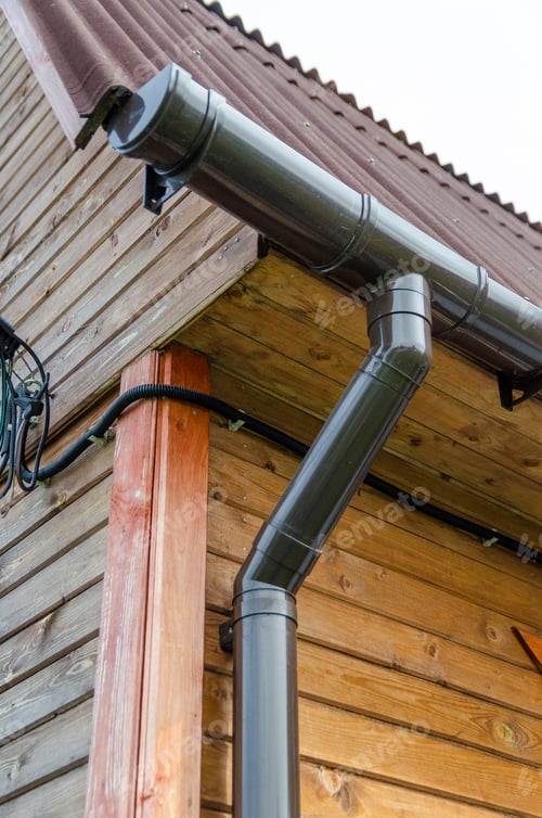 Preview: Drainpipe On The Wall Of A Wooden House