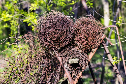 Preview: Woven Rusty Wire For Fences On A Metallic Prop With Natural Background