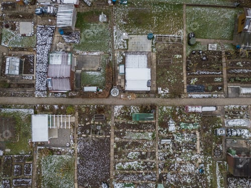 Preview: Aerial View Of Allotment In Winter With Snow Covered Roofs