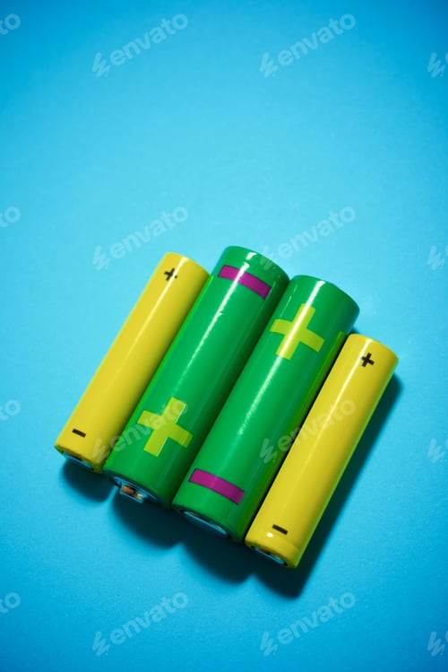 Preview: Small Batteries On A Blue Table.