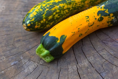 Preview: Unusual Green-Orange Zucchini On An Old Wooden Background