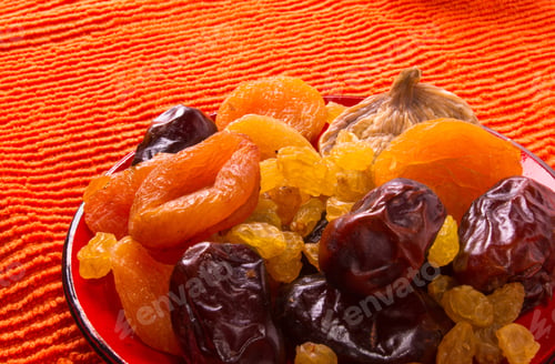 Preview: Various Dried Fruits On The Textile Orange Background