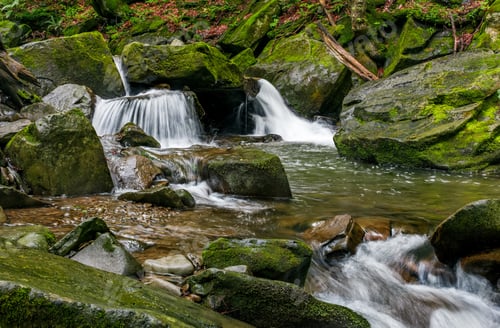 Preview: Small Cascades On The Forest River Among Huge Boulders Covered With Moss. Fresh And Clean Nature