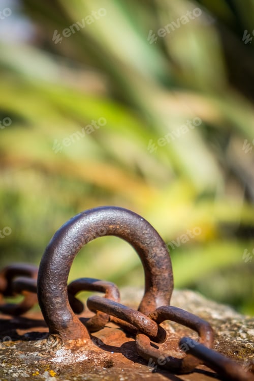 Preview: Old Rusted Chain Attached To The Stone Wall In The Port