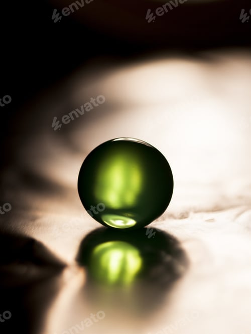 Preview: Abstract Composition With Beautiful, Green, Round Jelly Ball On An Aluminium Foil With Reflexion