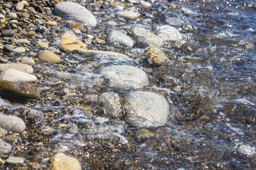 Preview: Sea Pebble Beach With Multicoloured Stones, Transparent Waves With Foam, On A Warm Summer Day