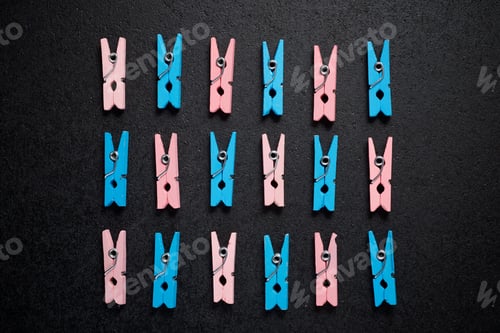 Preview: Small Clothespins On A Black Table.