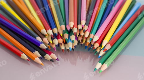 Preview: Group Of Sharp Colored Pencils With White And Red Background And Reflexions