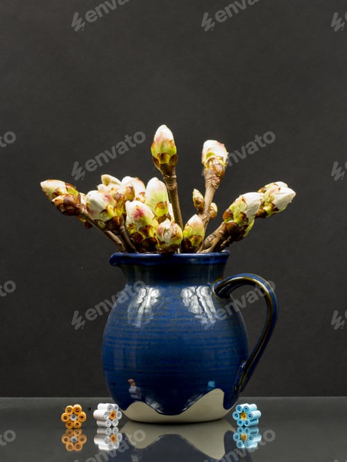 Preview: Still Life Composition With Chestnut Buds In A Blue Ceramic Pot And Paper Flowers With Reflections
